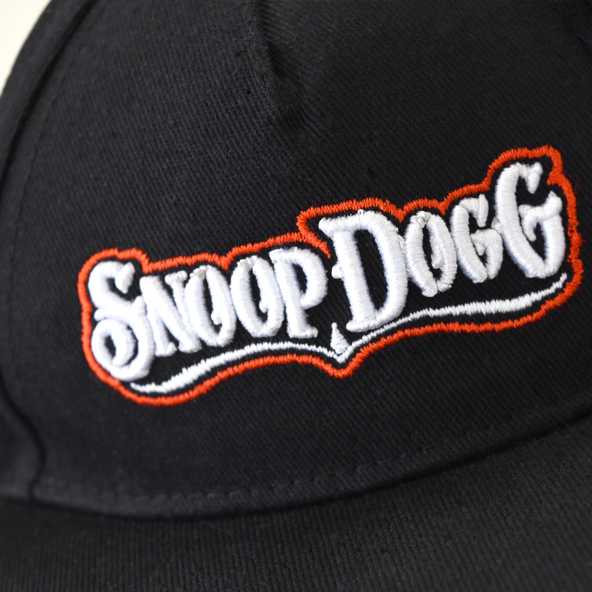 A close up detail image showing the puff embroidered Snoop Dogg wordmark on the Classic Snoop Deluxe Pet Baseball Hat.