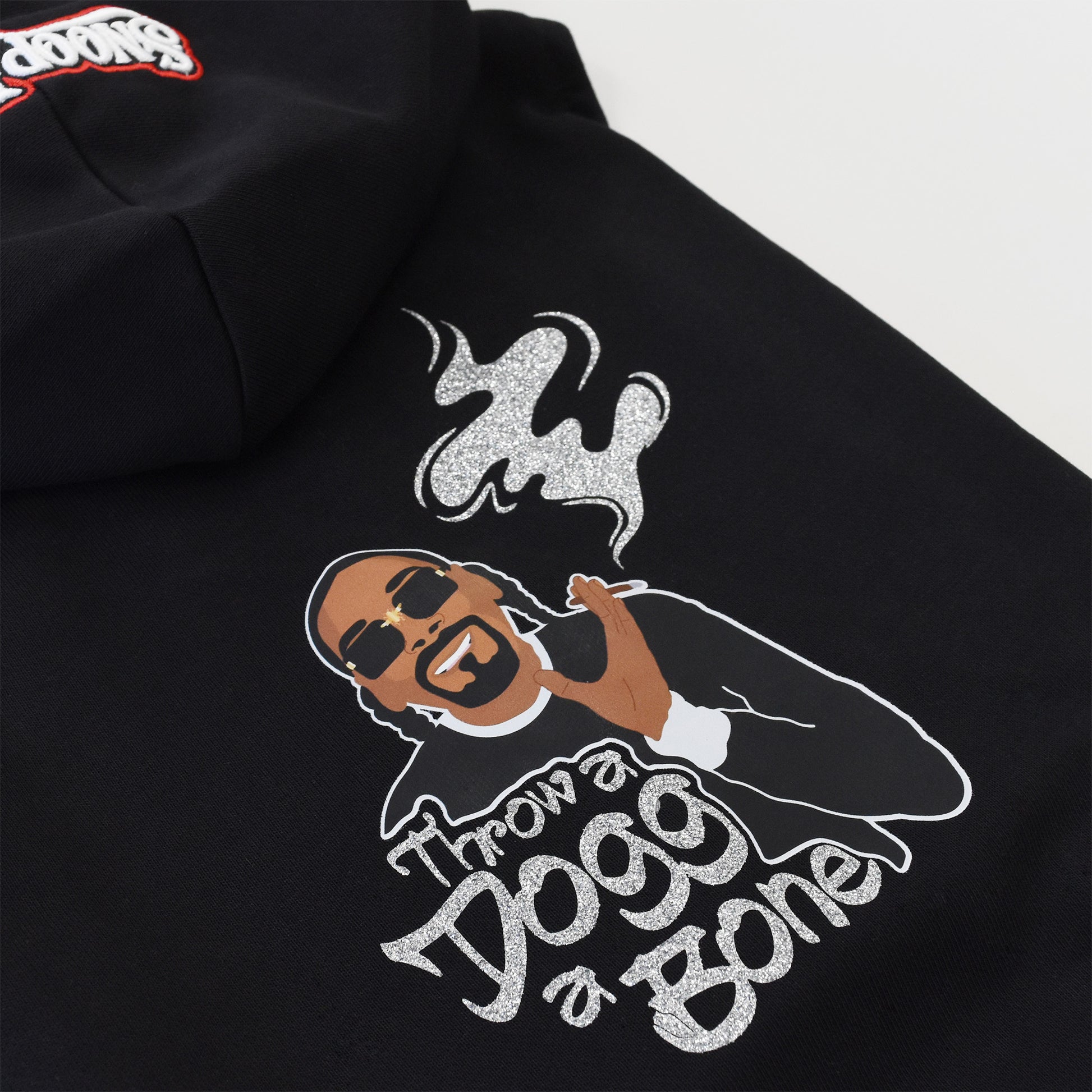 A close up of the Throw A Dogg A Bone Deluxe Pet Hoodie sparkle design.