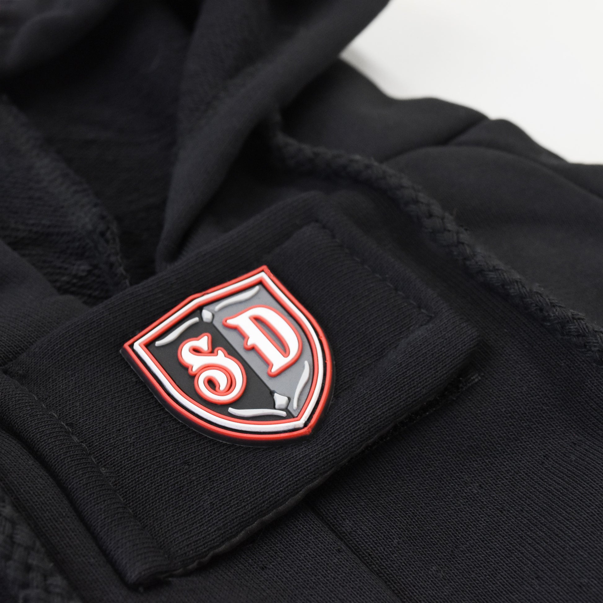 A close up detail image of the SD Micro Mold and velcro strap on the Mic Drop Deluxe Pet Hoodie.