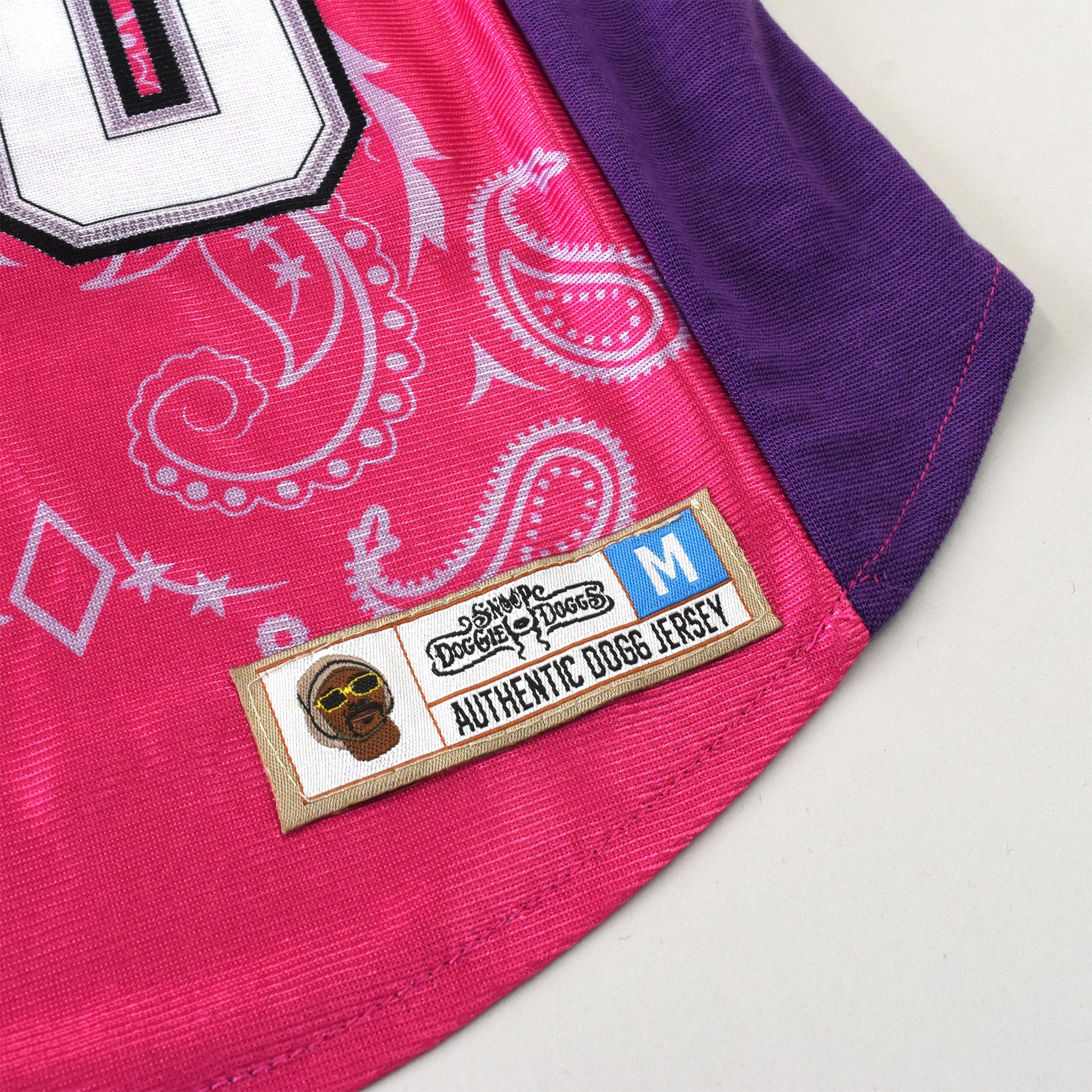 A close up detail image showing design sublimation, stretch fabric, and embroidered jersey tag of the Boss Lady Deluxe Pet Jersey.
