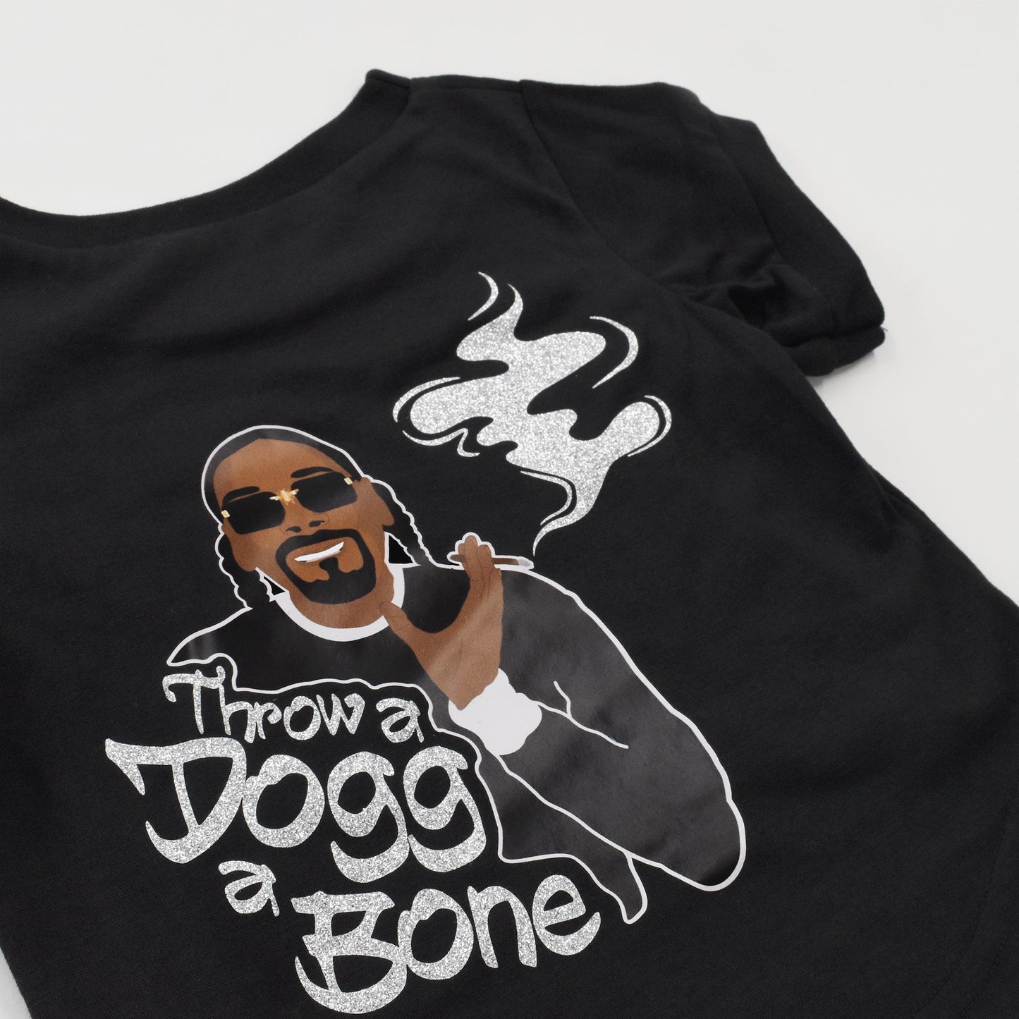 A close up of the Throw A Dogg A Bone Deluxe Pet T-Shirt sparkle design.